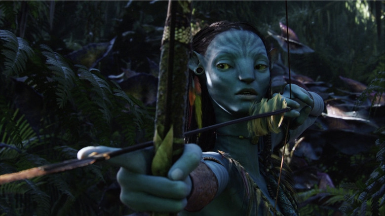 Neytiri aims a bow and arrow