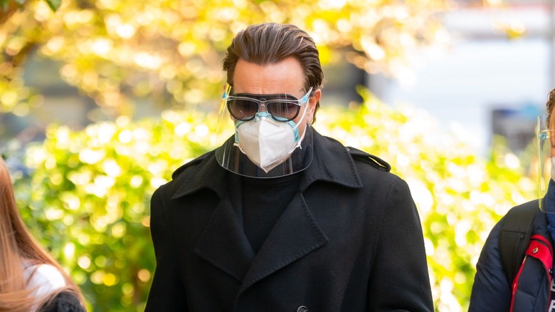 Ewan McGregor wearing PPE walking