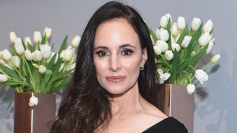 Madeleine Stowe stands near flowers