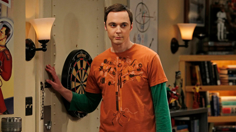 Jim Parsons leans on a door