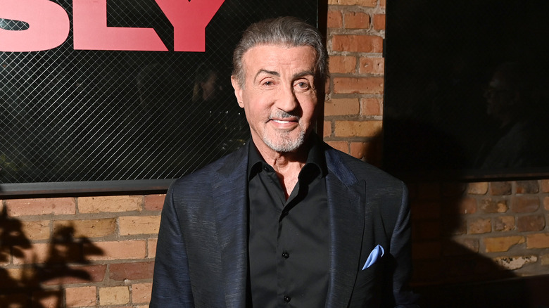 Sylvester Stallone smiling black jacket