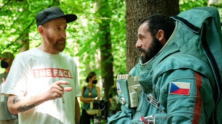 Renck stands next to Sandler on set