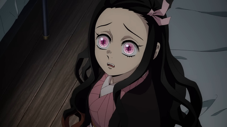 Worried Nezuko sitting on bed 