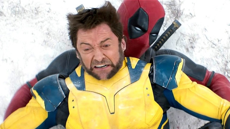 Wolverine lying down on Deadpool