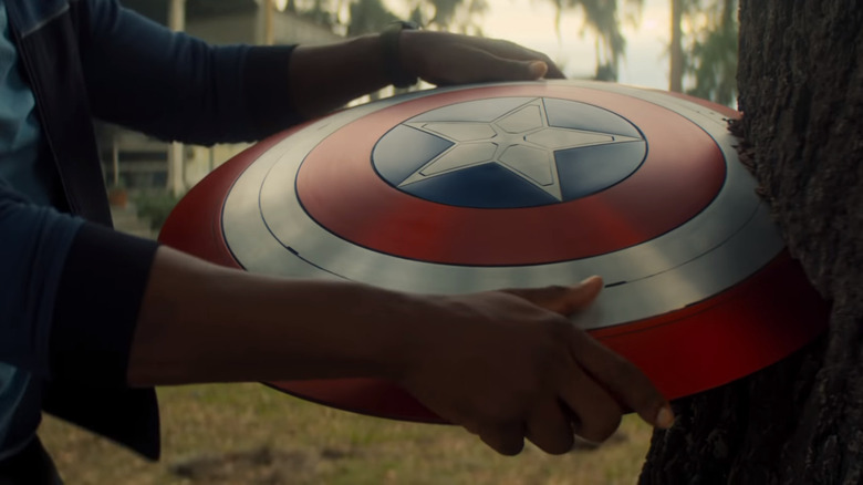 Hands holding Captain America's shield