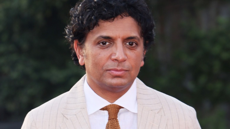 M. Night Shyamalan wearing suit