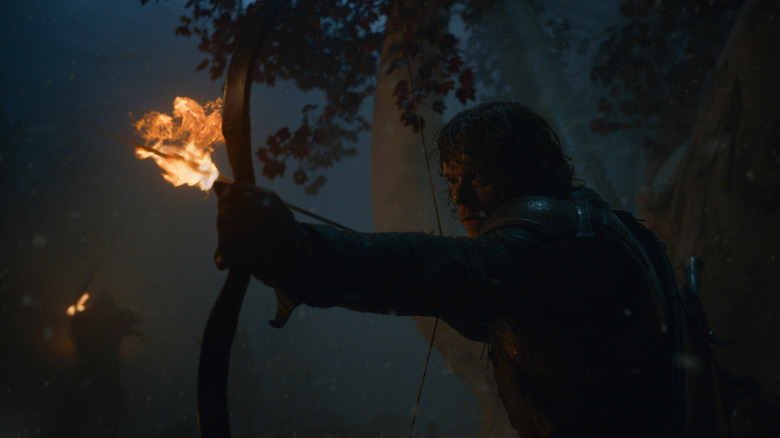 Theon aiming flaming arrow