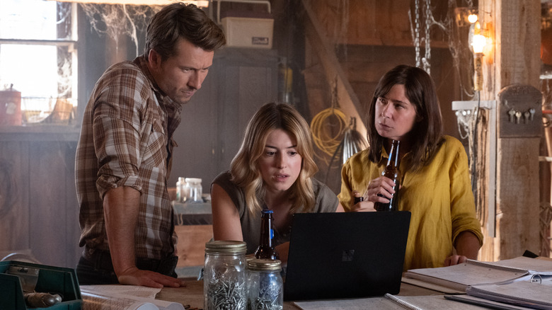 Tyler, Kate, and Cathy look at laptop